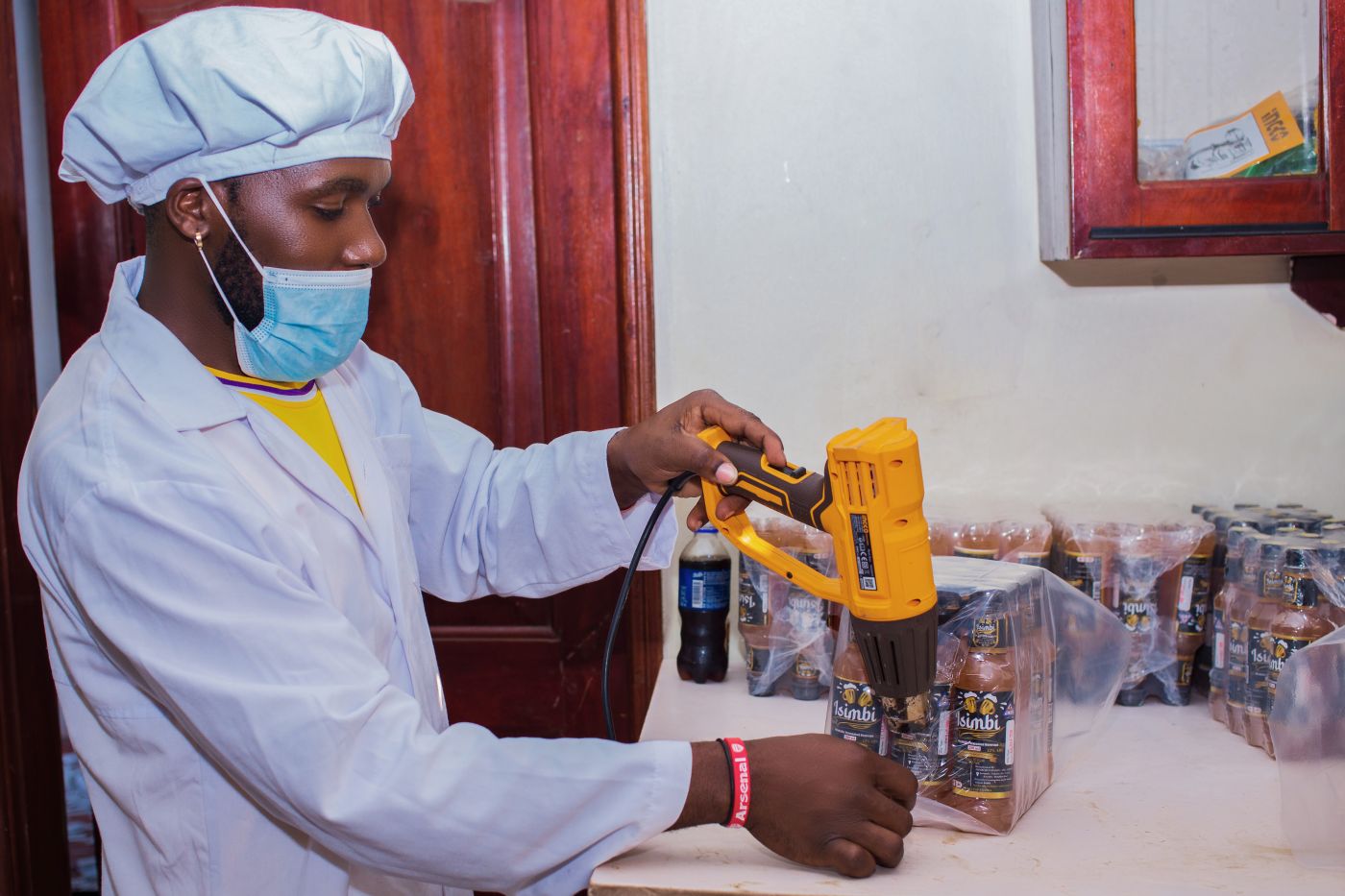 Quality control and pack-sealing at the Isimbi Beverages facility in Luzira