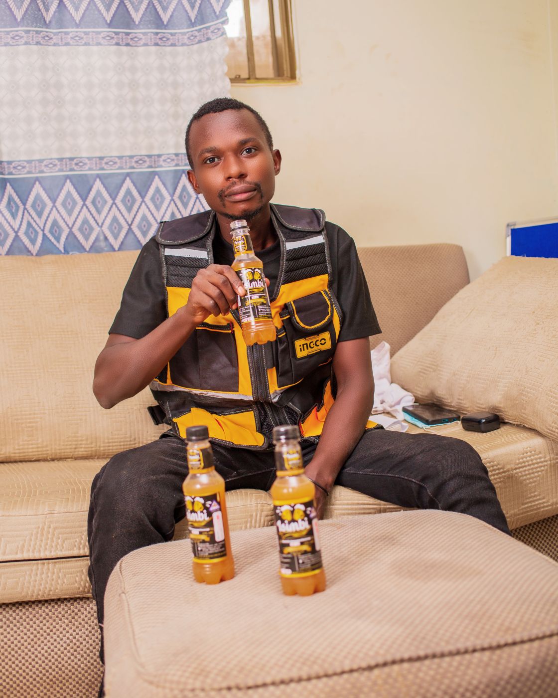 A customer with two bottles of Isimbi Wine at home